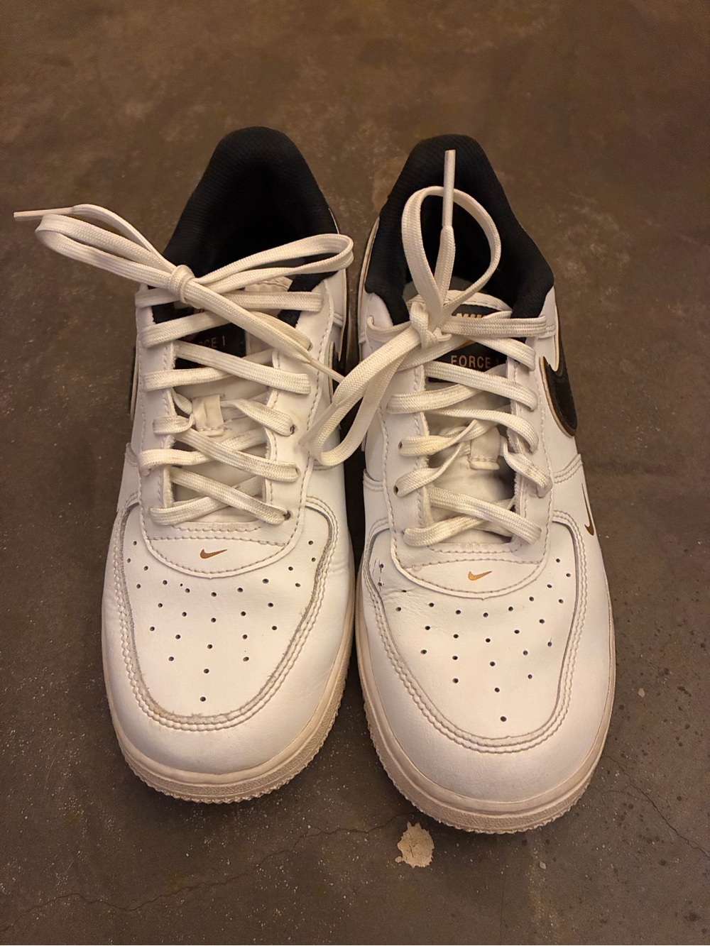 Nike White and Black Kids' Sneakers with Gold Swoosh Accents